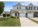 Inviting townhome features a one-car garage and well-maintained landscaping at 948 Consortium Dr, Raleigh, NC 27603