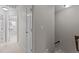 Upstairs hallway featuring neutral carpet and walls, multiple bedrooms, and access to stairs at 948 Consortium Dr, Raleigh, NC 27603