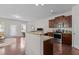 Open kitchen with granite countertops, stainless steel appliances, and modern cabinets at 948 Consortium Dr, Raleigh, NC 27603