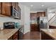 Well-equipped kitchen with granite counters, stainless appliances and dark wood cabinets at 948 Consortium Dr, Raleigh, NC 27603