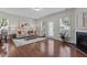 Sun-filled living room with hardwood floors, modern furniture, and a fireplace at 948 Consortium Dr, Raleigh, NC 27603