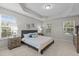 Bright main bedroom featuring carpet floors, neutral paint, tray ceiling, and lots of natural light at 948 Consortium Dr, Raleigh, NC 27603