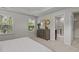 Bright main bedroom featuring carpet floors, neutral paint, modern furniture, and an ensuite bathroom at 948 Consortium Dr, Raleigh, NC 27603