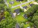 Overhead view of home with a fenced yard, detached garage, and close proximity to neighbors and mature trees at 1015 S 1St St, Smithfield, NC 27577