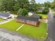 An aerial view captures a brick single-story home with a well-maintained lawn at 1015 S 1St St, Smithfield, NC 27577