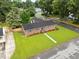 An aerial view captures a brick single-story home with a well-maintained lawn at 1015 S 1St St, Smithfield, NC 27577