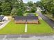 An aerial view captures a brick single-story home with a well-maintained lawn at 1015 S 1St St, Smithfield, NC 27577