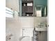 Neat bathroom equipped with white tile, a toilet, and sink with storage space at 1015 S 1St St, Smithfield, NC 27577