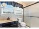 Well-lit bathroom with a walk-in shower, black vanity and large mirror at 1015 S 1St St, Smithfield, NC 27577