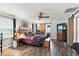 Spacious bedroom with ceiling fan, barn door to bathroom, dresser and dark wood floors at 1015 S 1St St, Smithfield, NC 27577