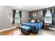 Stylish bedroom offering dual windows, hardwood floors, and comfortable furnishings at 1015 S 1St St, Smithfield, NC 27577