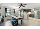 Cozy dining area features wood table with blue cushioned seating, adjacent to an open kitchen at 1015 S 1St St, Smithfield, NC 27577