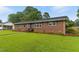 Charming single-story brick home featuring a lush green lawn and a welcoming entryway at 1015 S 1St St, Smithfield, NC 27577