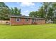 Charming single-story brick home featuring a lush green lawn and a welcoming entryway at 1015 S 1St St, Smithfield, NC 27577