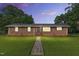 Charming single-story brick home featuring a lush green lawn and a welcoming entryway at 1015 S 1St St, Smithfield, NC 27577