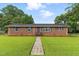 Charming single-story brick home featuring a lush green lawn and a welcoming entryway at 1015 S 1St St, Smithfield, NC 27577