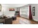 A well-lit living room showcases hardwood floors, a gray sofa, and neutral walls at 1015 S 1St St, Smithfield, NC 27577