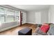 A well-lit living room showcases hardwood floors, a gray sofa, and neutral walls at 1015 S 1St St, Smithfield, NC 27577