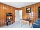 Versatile room offers office capabilities with wood paneling and neutral carpet at 1015 S 1St St, Smithfield, NC 27577