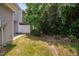 Backyard with a white privacy fence borders a patio and wooded area at 102 Harvest Oaks Lane # 38, Durham, NC 27703