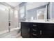 Well-lit bathroom featuring a double vanity, a large mirror, and a tiled walk-in shower at 102 Harvest Oaks Lane # 38, Durham, NC 27703
