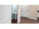 Half bathroom with a pedestal sink and white fixtures located near the entrance at 102 Harvest Oaks Lane # 38, Durham, NC 27703
