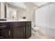 Well-lit bathroom with a single vanity, dark wood cabinets, and a shower with a curtain at 102 Harvest Oaks Lane # 38, Durham, NC 27703