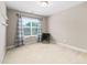 Carpeted bedroom features a window with curtains and a black chair at 102 Harvest Oaks Lane # 38, Durham, NC 27703
