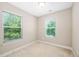 A carpeted bedroom space with two windows that provide ample natural light at 102 Harvest Oaks Lane # 38, Durham, NC 27703