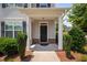 Inviting front porch with classic columns and well-maintained landscaping at 102 Harvest Oaks Lane # 38, Durham, NC 27703