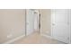 A hallway with neutral walls and carpet leading to multiple doorways, showcasing the home's layout at 102 Harvest Oaks Lane # 38, Durham, NC 27703
