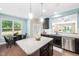 Open-concept kitchen with stainless steel appliances, a granite island, and a view into the adjacent dining area at 102 Harvest Oaks Lane # 38, Durham, NC 27703