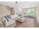 Bright living room with hardwood flooring, sectional sofa, and neutral decor at 102 Harvest Oaks Lane # 38, Durham, NC 27703