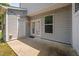 Concrete patio area with white doors, window, and exterior access to the outside area at 102 Harvest Oaks Lane # 38, Durham, NC 27703