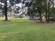 Mature trees frame a charming home in this expansive yard, blending shade and sunlight at 10248 Nc-43, Rocky Mount, NC 27801