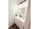 This bathroom features modern lighting, luxury vinyl flooring, and a sink with new fixtures at 103 Cimmaron Ct, Cary, NC 27511
