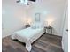 This neutral bedroom features luxury vinyl flooring, ceiling fan, and bedside tables with lamps at 103 Cimmaron Ct, Cary, NC 27511