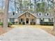 Lovely one-story brick home with gray siding, a black front door, and a long driveway at 103 Cimmaron Ct, Cary, NC 27511
