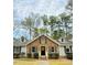 Beautiful one-story brick home featuring manicured bushes, a black door and dormer windows at 103 Cimmaron Ct, Cary, NC 27511