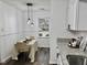This well-lit dining nook has luxury vinyl flooring, neutral paint, granite counters, and modern lighting at 103 Cimmaron Ct, Cary, NC 27511