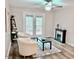 Inviting living space with a decorative fireplace, cozy armchairs, and access to the outdoor area at 103 Cimmaron Ct, Cary, NC 27511