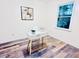 This office features luxury vinyl flooring, modern decor, a window, and a minimalist desk at 103 Cimmaron Ct, Cary, NC 27511
