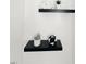 Floating wall shelves with plants and decor enhance the minimalist aesthetic of this bathroom at 103 Cimmaron Ct, Cary, NC 27511