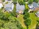 Aerial view of a well maintained home, with a screened porch, deck, and patio amongst lush backyard landscaping at 11124 Penderwood Ct, Raleigh, NC 27617