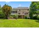 Well-maintained backyard features a screened porch, deck, patio, and manicured landscaping, perfect for outdoor living at 11124 Penderwood Ct, Raleigh, NC 27617