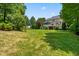 Expansive, well-manicured backyard featuring lush green lawn and mature trees, perfect for outdoor activities and relaxation at 11124 Penderwood Ct, Raleigh, NC 27617