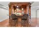 Finished basement bar with paneled wood and granite countertop perfect for entertainment and socializing at 11124 Penderwood Ct, Raleigh, NC 27617