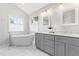 Bright bathroom with a free standing tub and granite countertops at 11124 Penderwood Ct, Raleigh, NC 27617
