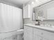 Bathroom featuring double sinks, modern fixtures, and a shower-tub combination at 11124 Penderwood Ct, Raleigh, NC 27617