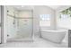 Stylish bathroom boasts a glass-enclosed shower, soaking tub, and elegant tile work at 11124 Penderwood Ct, Raleigh, NC 27617